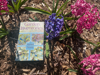 Image of book on mulch and between flowers